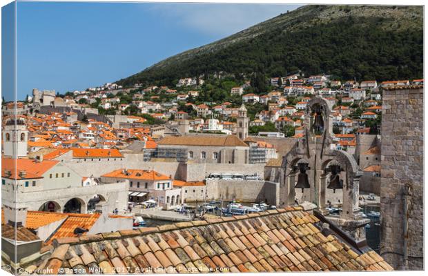 Overlooking the bells on a church towards the old  Canvas Print by Jason Wells