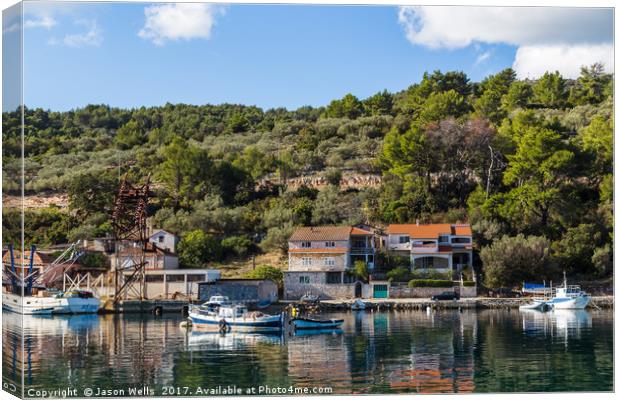 Green trees and shrubs behind Vela Luka harbour Canvas Print by Jason Wells