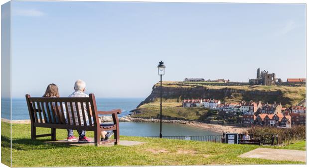 Couple on a bench overlooking Whitby harbour Canvas Print by Jason Wells