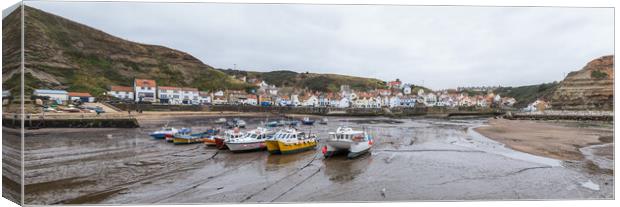 Boats lined up in the bay at Staithes at low tide Canvas Print by Jason Wells