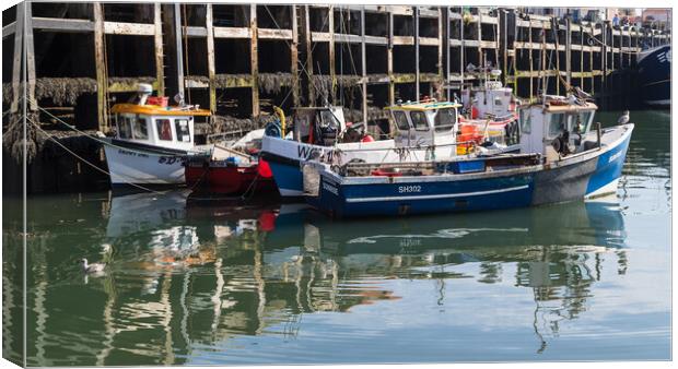 Cluster of fishing boats in Scarborough harbour Canvas Print by Jason Wells