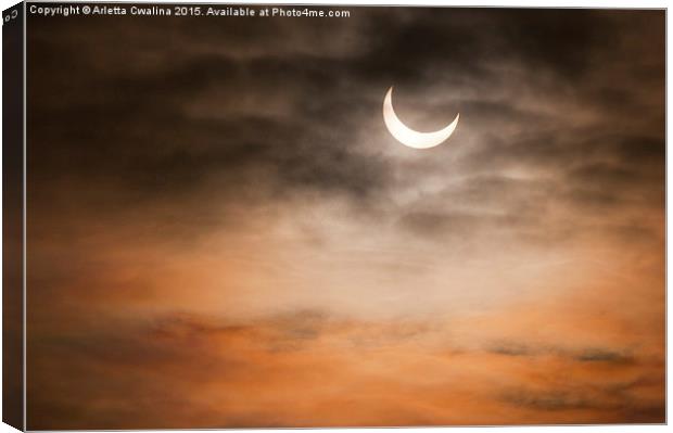 Partial solar eclipse and clouds morning sky  Canvas Print by Arletta Cwalina