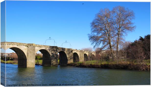Bridge over the L'Aude River in France Canvas Print by Ann Biddlecombe