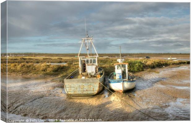 Low tide boats at Brancaster Canvas Print by Sally Lloyd