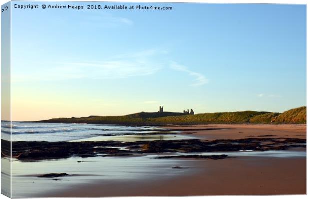 Majestic dawn over Dunstanburgh Castle Canvas Print by Andrew Heaps