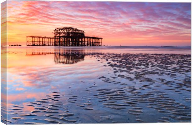 Sunrise over the West Pier (Brighton) Canvas Print by Andrew Ray