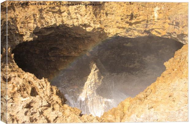 Rainbows in Blow Hole Canvas Print by Jane Emery