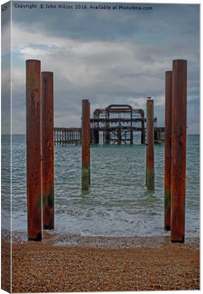 Old Pier in Brighton Canvas Print by John Wilcox