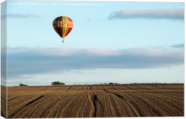 Ballooning over farmland Canvas Print by Susan Tinsley