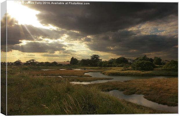 The sun breaks through over the winter saltmarsh Canvas Print by James Tully