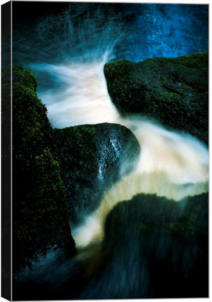 Flow between dark rocks Canvas Print by Andrew Kearton