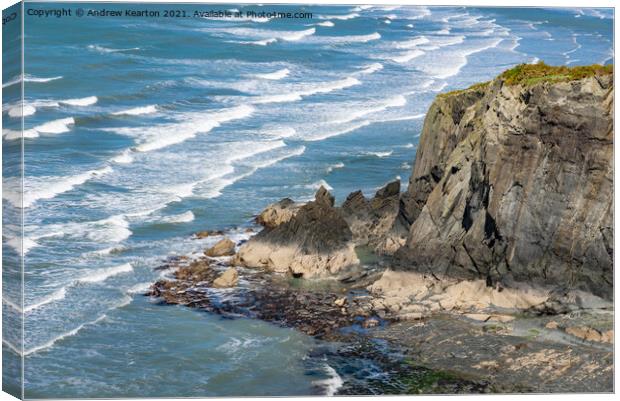 Waves and rocky cliffs at Newport, Pembrokeshire Canvas Print by Andrew Kearton