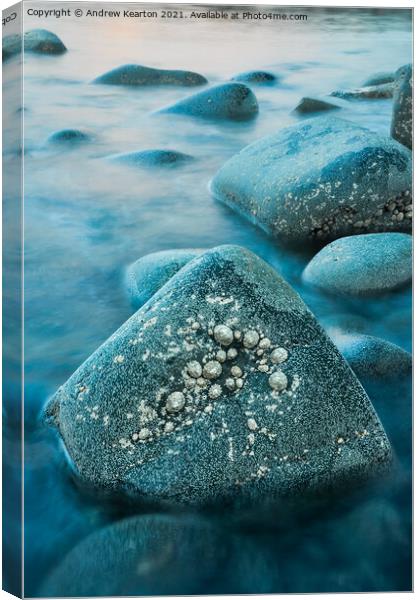 Rising tide around rocks at dusk Canvas Print by Andrew Kearton