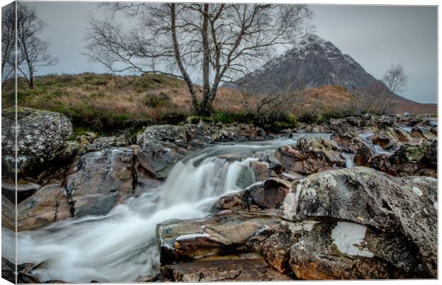 Low Winter waterflows past the Buckle Canvas Print by John Malley