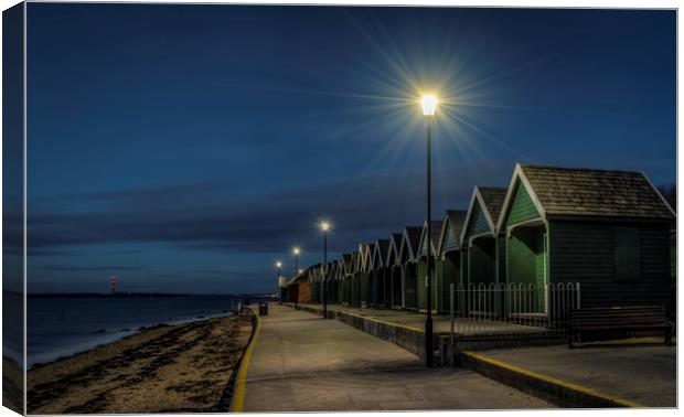 Beach Huts at Gurnard bay at dusk Canvas Print by David Oxtaby  ARPS