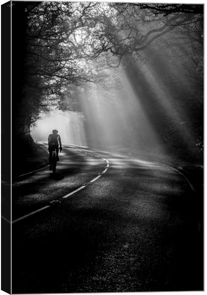 Cycling through the mist Canvas Print by Jonathan Smith