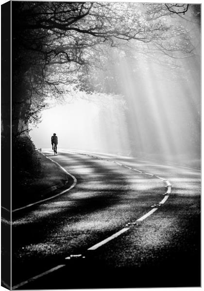 Cycling through the mist 3 Canvas Print by Jonathan Smith