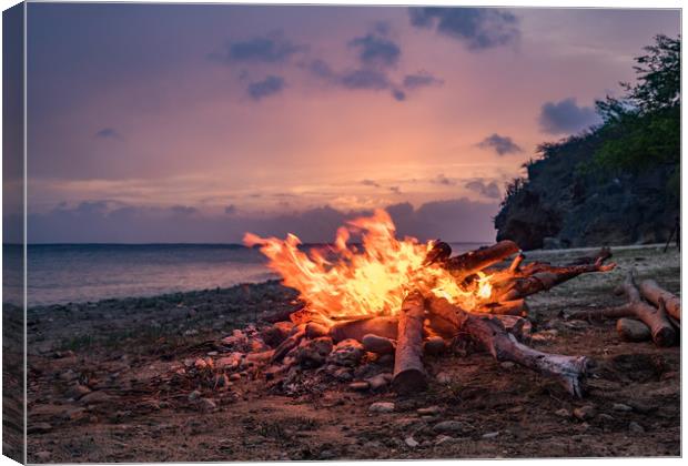 A fantastic sunset at the beach with a bonfire and Canvas Print by Gail Johnson