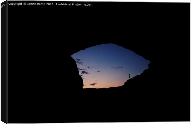 Sunrise through the North Window Arch Canvas Print by Adrian Beese