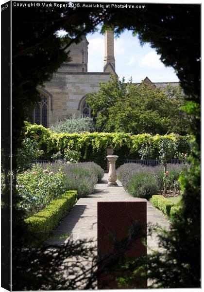 Garden through hole in hedge Canvas Print by Mark Roper