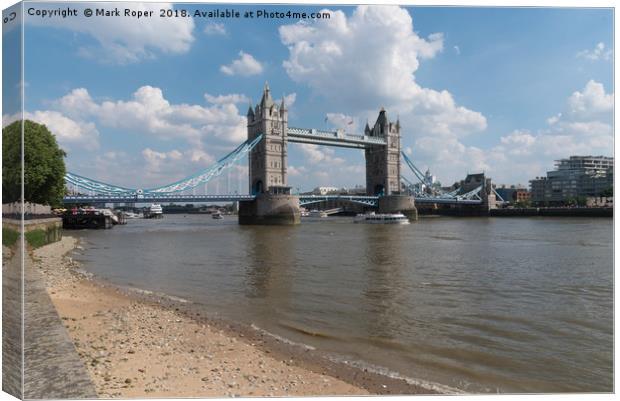 Tower Bridge in London with Thames shoreline Canvas Print by Mark Roper
