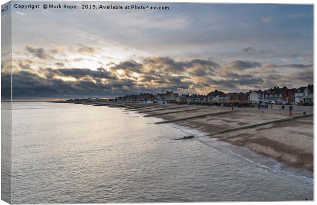 Felixstowe seafront with golden sun behind clouds  Canvas Print by Mark Roper