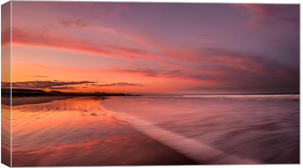 Bamburgh beach red sunset Canvas Print by Naylor's Photography