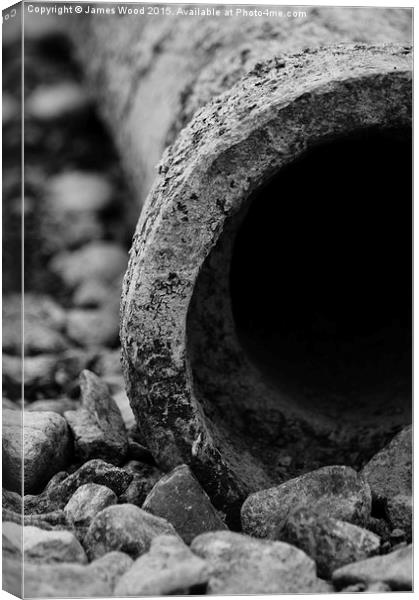 Pipe and pebbles Canvas Print by James Wood