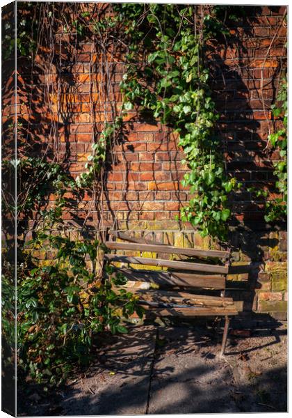 Old Wooden Broken Bench By The Brick Wall Canvas Print by Artur Bogacki