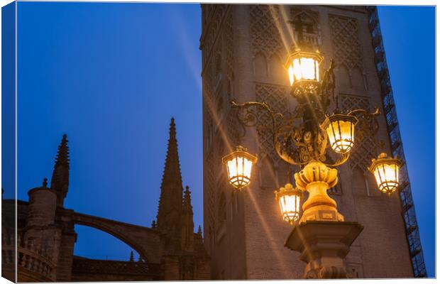 Fuente De La Farola Lamp Against Giralda Tower In Seville Canvas Print by Artur Bogacki