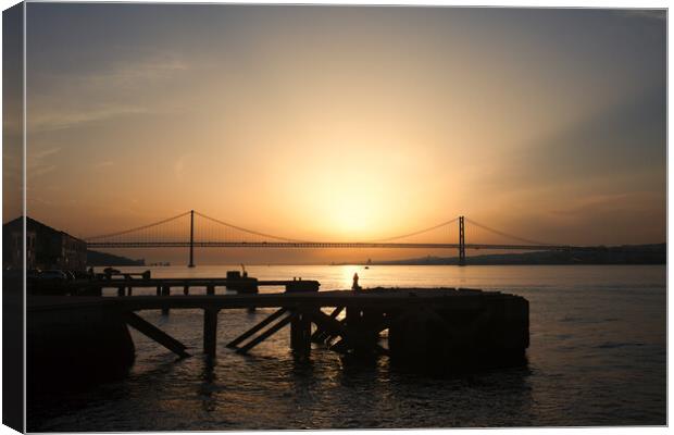 Sunset at Almada Quay and 25 de Abril Bridge in Lisbon Canvas Print by Artur Bogacki