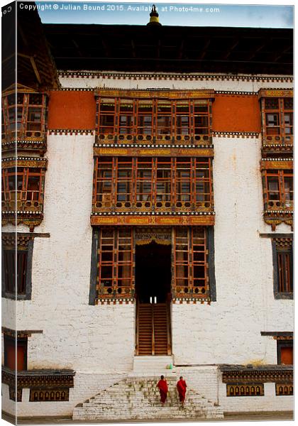 Two monks of Tashi Chho Dzong Fortress, Bhutan Canvas Print by Julian Bound