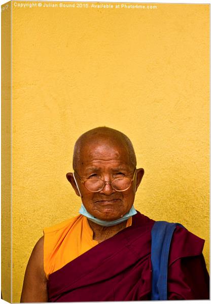 Elderly Tibetan Buddhist monk, Boudhanath, Kathman Canvas Print by Julian Bound