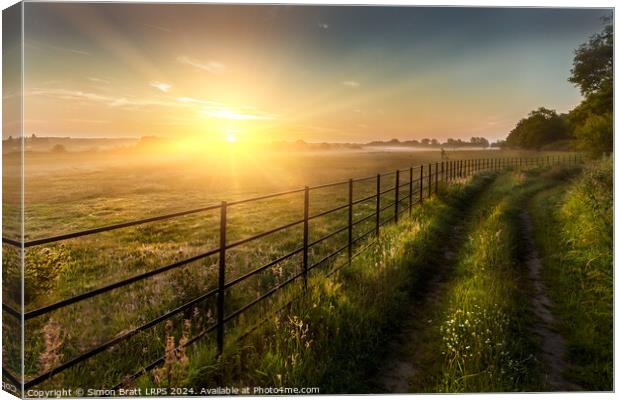 Super sunrise over farm fields cattle fence and track Canvas Print by Simon Bratt LRPS
