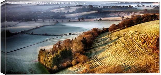 Dawn breaking over wrinkled hill Canvas Print by Simon Bratt LRPS