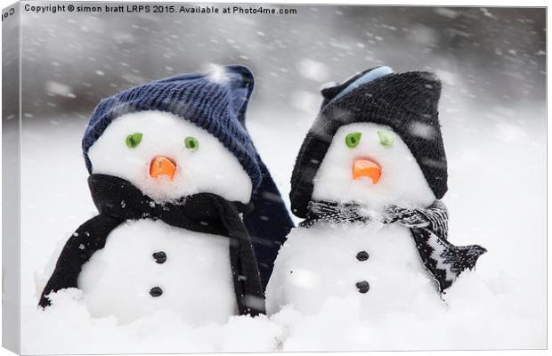 Two cute snowmen dressed for winter Canvas Print by Simon Bratt LRPS