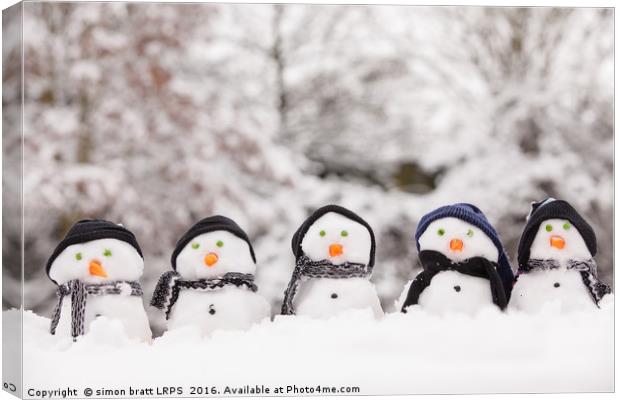 Five cute snowmen facing forward Canvas Print by Simon Bratt LRPS