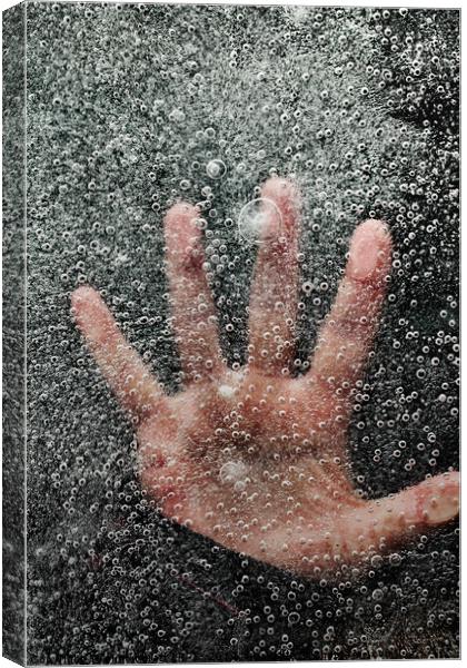 Mans hand below frozen lake drowning Canvas Print by Simon Bratt LRPS