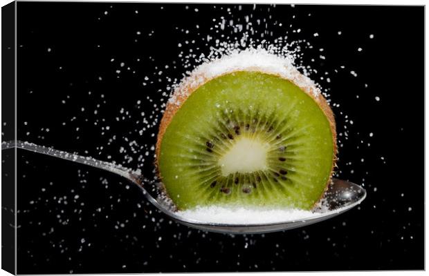 Kiwi fruit cut in half on a spoon with sugar Canvas Print by Simon Bratt LRPS