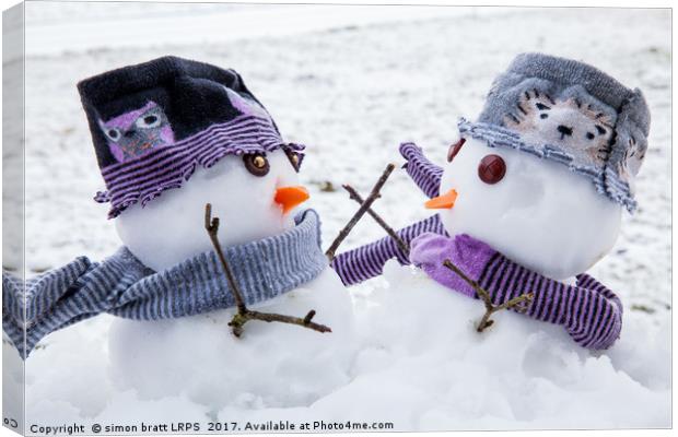 Two cute snowmen friends embracing Canvas Print by Simon Bratt LRPS