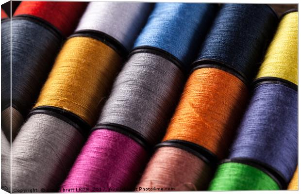 Colorful cotton reels viewed at an angle Canvas Print by Simon Bratt LRPS