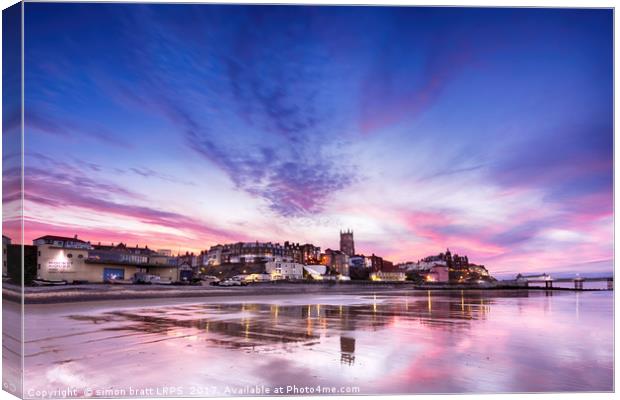 Cromer pier and town in Norfolk with pink sunset Canvas Print by Simon Bratt LRPS