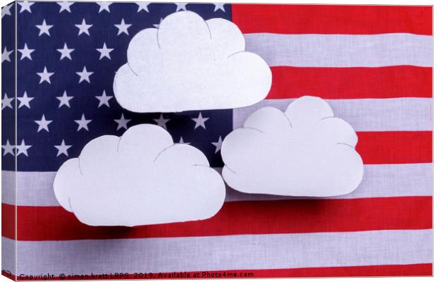 American flag with three white clouds floating abo Canvas Print by Simon Bratt LRPS