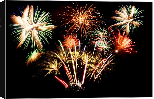 Many firework explosions in the sky Canvas Print by Simon Bratt LRPS
