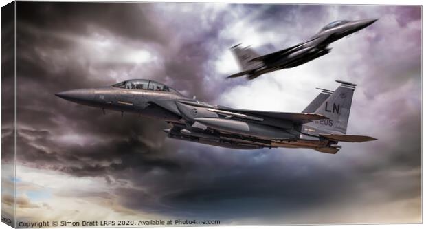 Two F-15E fighter jets passing in storm clouds Canvas Print by Simon Bratt LRPS