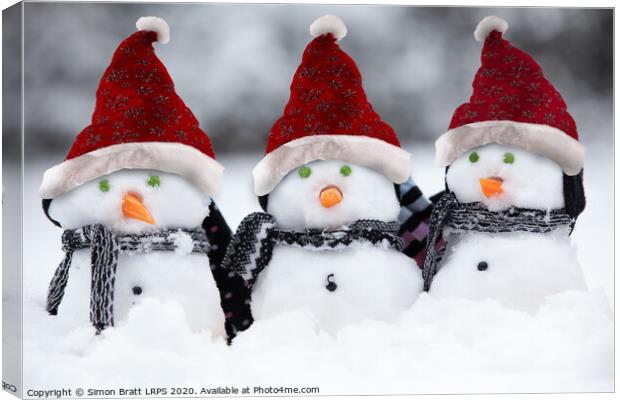 Snowmen with Christmas hats Canvas Print by Simon Bratt LRPS