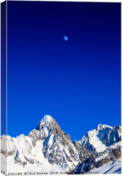 Moon above the French Alps against a deep blue sky Canvas Print by Chris Warham