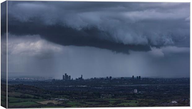 The City of Manchester under stormy skies Canvas Print by John Finney