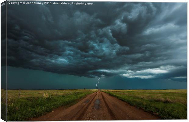  Lightning, End of the road. Tornado alley, USA.  Canvas Print by John Finney