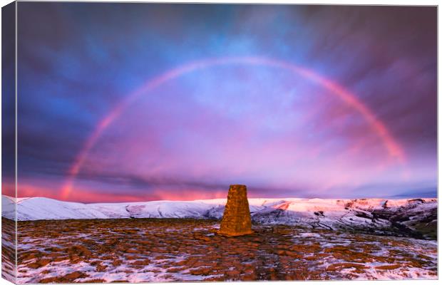 Winter rainbow over Mam Tor summit, Derbyshire Canvas Print by John Finney